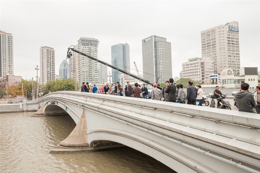 Film crew and camera crane on a Shanghai city location.