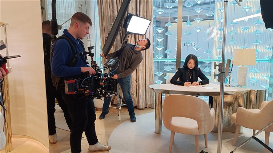 Corporate video crew filming an interview setup in Shanghai.