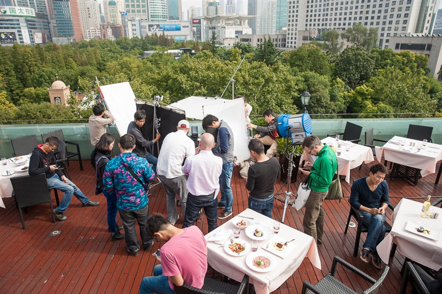 Corporate production crew filming on a Shanghai rooftop location.